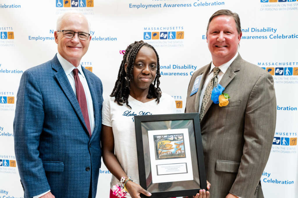 Senator Barrett receives an award from an advocate.