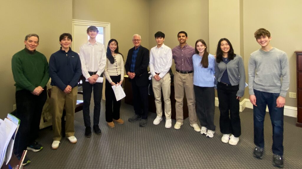 Senator Barrett stands in his State House office with a group of young constituents.